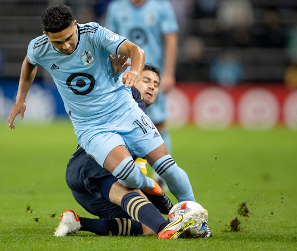 Emanuel Reynoso (10) of Minnesota United FC is slide tackled by Alejandro Bedoya (11) of Philadelphia Union in the first half Wednesday, Oct. 20 at Al