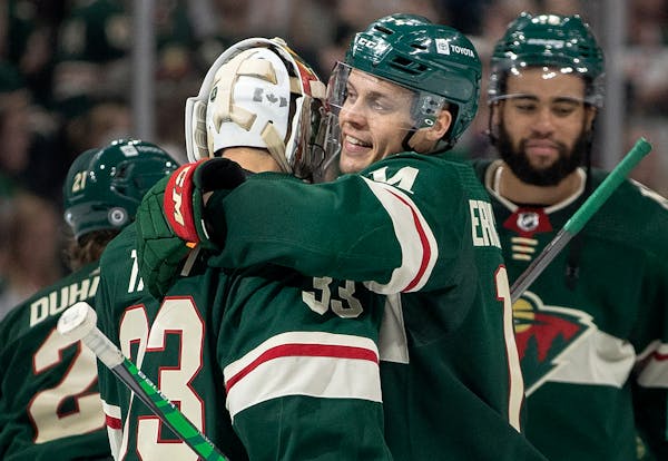 Joel Eriksson Ek and Minnesota Wild goalie Cam Talbot (33) celebrate at the end of the game Tuesday, Oct. 19 at Xcel Energy Center in St. Paul, Minn. 