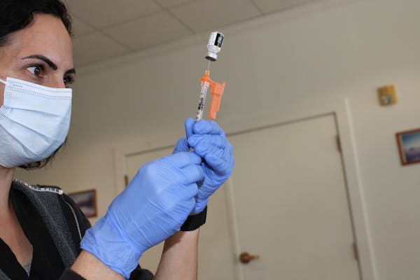 Christina Ponce, a public health nurse for Contra Costa County, California, fills syringes with the Pfizer-BioNTech COVID-19 vaccine. 