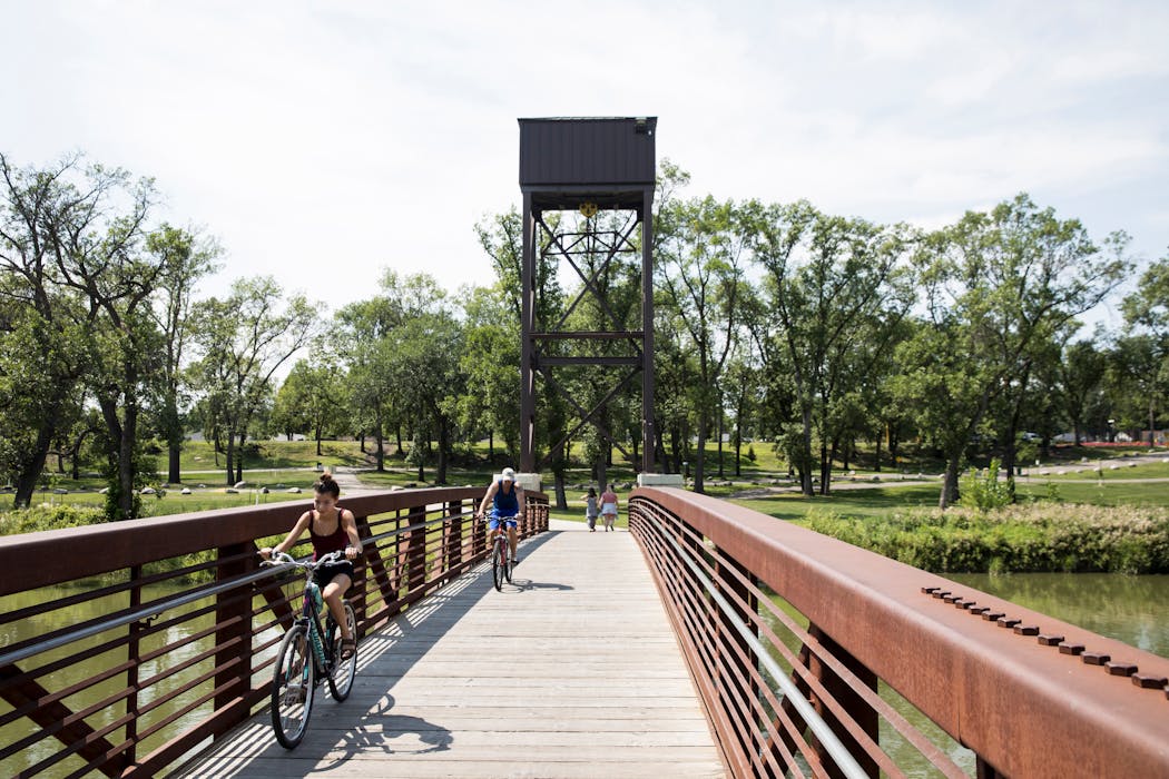 Bikers cross a bridge over the Red River between Fargo, N.D. and Moorhead, Minn. in 2018.