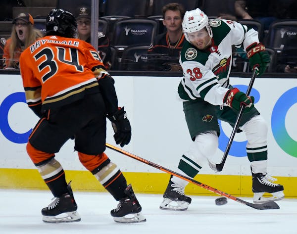 Ryan Hartman of the Wild shot past Jamie Drysdale of the Ducks on Oct. 15 as the teams opened the NHL season in Anaheim.