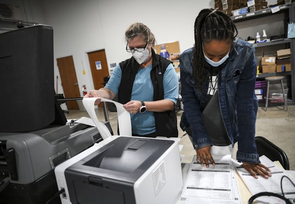 Election judges Kathy Bonnifield, left, and Bretaina Brigham on Friday confirmed the tabulated results from a batch of test ballots fed into a voting 