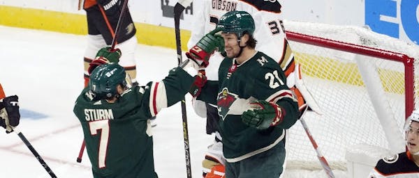 Wild winger Brandon Duhaime (21) was congratulated by teammate Nico Sturm on his somewhat fluky first NHL goal Saturday night against the Ducks.