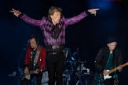 Mick Jagger, Ronnie Wood, left, and Keith Richards with drummer Steve Jordan performed Sunday at U.S. Bank Stadium. One fan called the event “a very