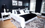 A black velvet headboard complements a bold black animal print embossed wallpaper in this master bedroom.
