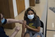 About 505,000 Minnesota children ages 5-11 will become eligible for the lower-dose Pfizer vaccine when approved. Alison Alquicira, 13, received her fi
