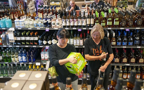 Kimberly Franek and her mother, Anne Booher, browsed Lakeville Liquors on Friday. Lakeville was the biggest moneymaker in the state, turning a $1.7 mi