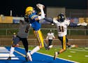 Hastings High School wide receiver Stephen Reifenberger (11) catches a touchdown in the first quarter while being defended by Bloomington Kennedy High