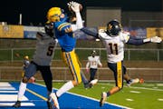 Hastings High School wide receiver Stephen Reifenberger (11) catches a touchdown in the first quarter while being defended by Bloomington Kennedy High