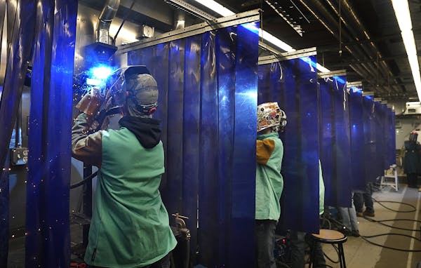 Pine Technical and Community College welding program student Joshua Hasching, left, welded in the college’s mobile welding lab, where students have 