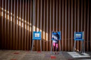 Voters cast their ballots Tuesday at Temple of Aaron in St. Paul.