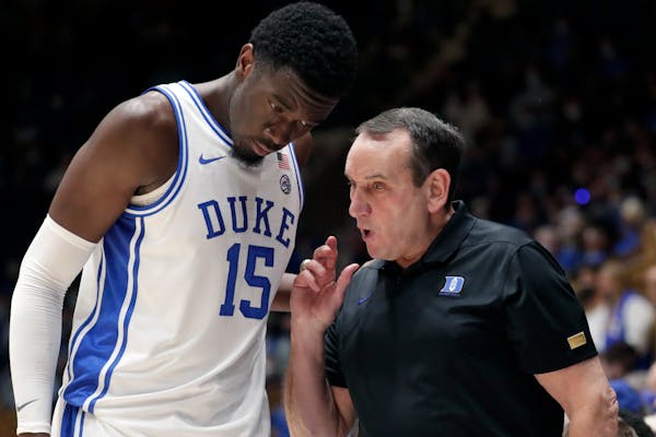 Duke center Mark Williams (15) listed to coach Mike Krzyzewski during a Blue Devils game.