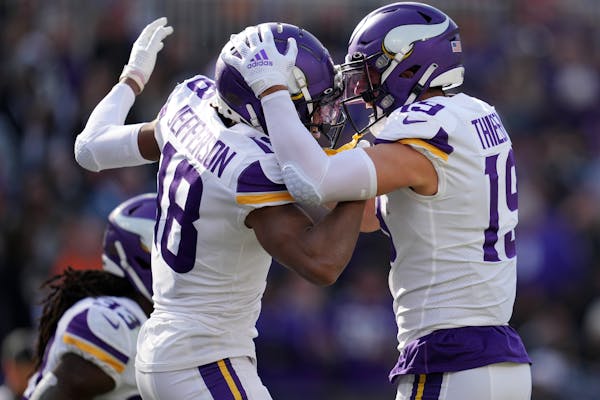 Vikings receivers Justin Jefferson (18) and Adam Thielen celebrate Jefferson’s 50-yard touchdown catch in the first quarter.