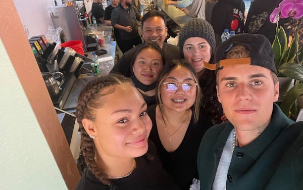 Justin Bieber posed with staff at the Lotus restaurant in Minneapolis on Sunday.