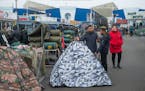 Migrants heading to European countries looked at camping gear at the Zhdanovichi market in Minsk, Belarus, on Saturday.