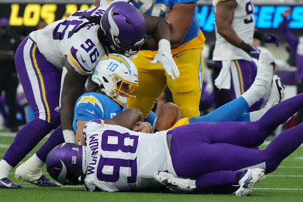 Minnesota Vikings safety Camryn Bynum (43) sacked Los Angeles Chargers quarterback Justin Herbert (10) in the third quarter of an NFL game between the