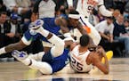 Wolves guard Patrick Beverley (22) and forward Jarred Vanderbilt (8) tumbled to the ground with Phoenix guard Mikal Bridges (25) on Monday.