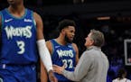 Minnesota Timberwolves center Karl-Anthony Towns (32) takes with Minnesota Timberwolves head coach Chris Finch in the fourth quarter against Phoenix.