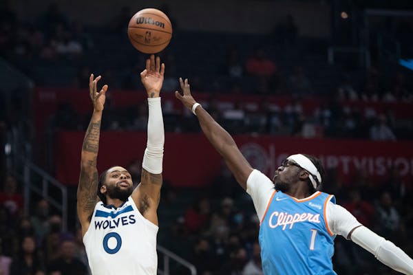 Minnesota Timberwolves guard D'Angelo Russell (0) shoots over Los Angeles Clippers guard Reggie Jackson (1) during the first half of an NBA basketball