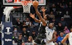 Wolves guard Anthony Edwards (right, guarding Kings forward Harrison Barnes during the first half Wednesday) scored 16 of his 26 points in the fourth 
