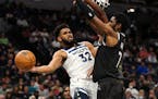 Karl-Anthony Towns passes the ball while the Kings’ Chimezie Metu defends in the third quarter.
