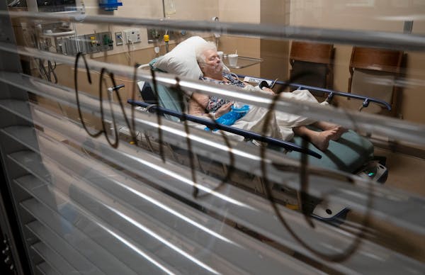 A patient rested in a COVID-positive room in the St. Cloud Hospital emergency room as she waited for an ICU bed to open up in November. CentraCare has