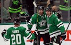 Dallas Stars' Ryan Suter (20) and Tyler Seguin (91) celebrate the overtime goal by right wing Denis Gurianov (34) against the Los Angeles Kings in an 