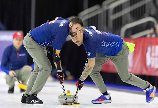 Team Shuster’s John Landsteiner, left, and Matt Hamilton swept to curl the rock while competing against Team Brundidge at the U.S. Olympic curling t