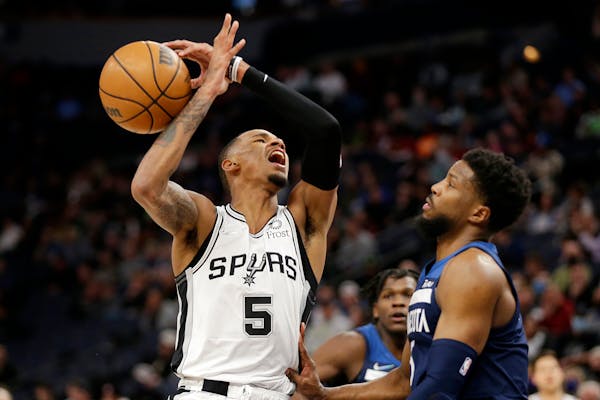 San Antonio guard Dejounte Murray had the ball knocked away by Timberwolves guard Malik Beasley in the second half 