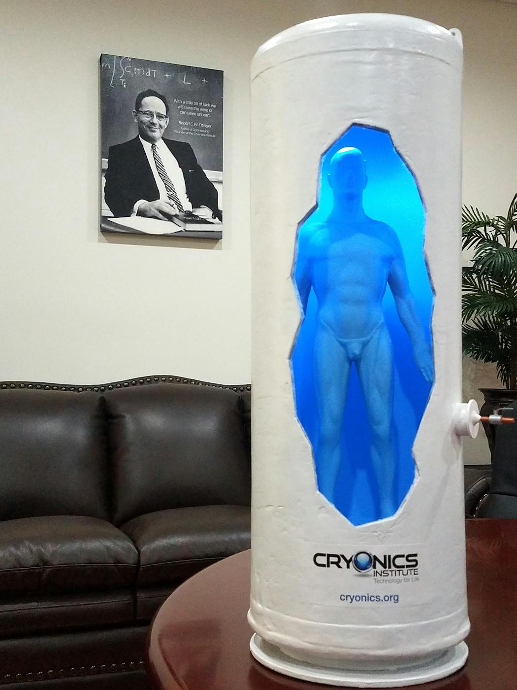 A model at the Cryonics Institute illustrates the inside of a cryostat. The photo in the background is of Robert Ettinger, founder of the Cryonics Institute, whose body is stored at the facility.
