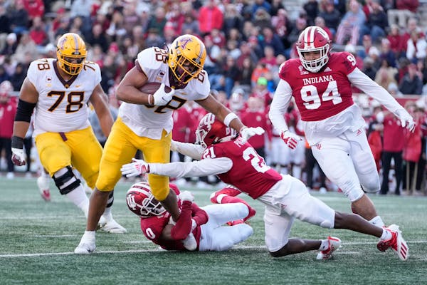 Minnesota tight end Brevyn Spann-Ford (88) is tackled by Indiana defenders Raheem Layne II (0) and Noah Pierre (21) in the first half Saturday. 