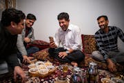 Khyber Malikzai, left, his newly immigrated brother Fahim, Sher Mulakhail and his newly arrived close friend Mirwais Momand talked over tea in Bloomin