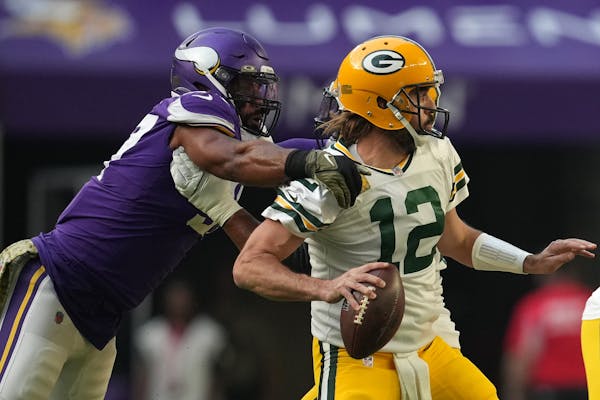 Vikings defensive end Everson Griffen got a hand on Packers quarterback Aaron Rodgers as he looked to throw a pass during the first quarter.