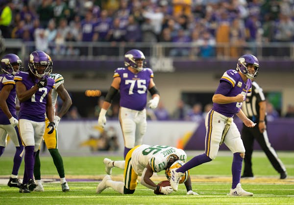 After what appeared to be a second-quarter interception by Packers safety Darnell Savage (26), Vikings quarterback Kirk Cousins (8) got a reprieve whe