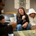 During a family game night on Monday, Nov. 22, Phillipe Jr., 11, laughed with his mom, Andrea Robinson, while another son, Romello, 17, drew a card. H