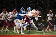Woodbury’s Joey Gerlach, shown leaping at the legs of Maple Grove’s Tanner Albeck, was named first team All-Metro on defense.