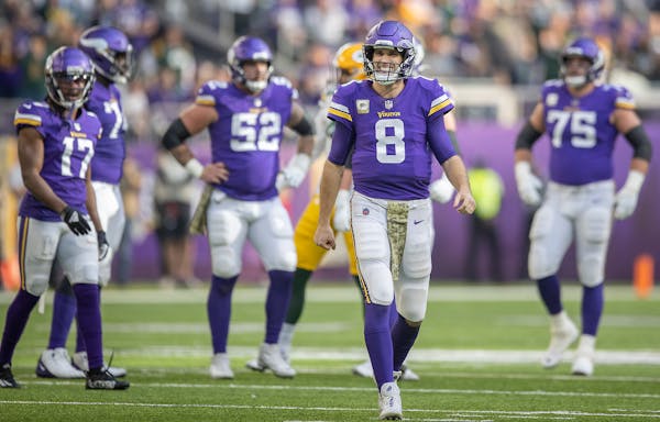 Vikings quarterback Kirk Cousins (8) grimaced after a roughing the passer was called against the Packers during the second quarter, Sunday, Nov. 21, 2