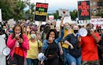 People march in the street on July 25, 2020, to protest the death of Elijah McClain in Aurora, Colo.