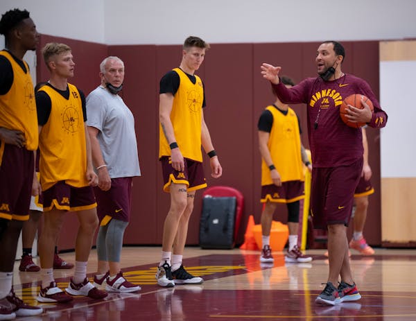 Gophers basketball coach Ben Johnson explained a drill to players earlier this season, along with assistant coach Dave Thorson (gray shirt). Johnson a
