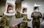 Air Force Airman 1st Class Shelby Matera, from left, and Capts. Aimee Clonts and Kimbrely Mason took part in an N95 mask fit check Tuesday at HCMC in 