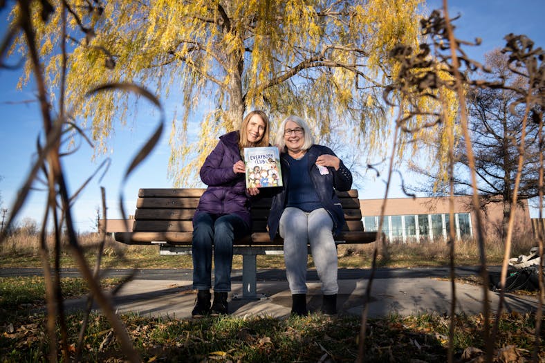 Nancy Loewen and Linda Hayen posed for a picture on a bench dedicated to Hayen’s daughter Carissa, who died in a car accident as a teenager. The two