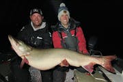Nolan Sprengeler, left, and Kevin Kray with the massive fish. The 57 3/4-inch muskie had a girth of 29 inches.