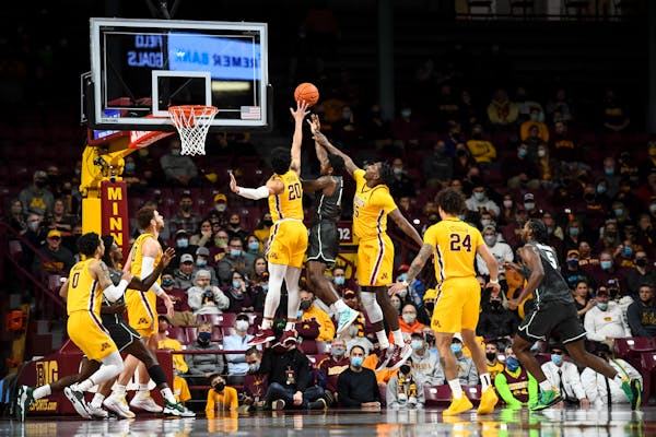 Gophers guard E.J. Stephens (20) and forward Charlie Daniels (15) defended against a shot by Jacksonville guard Jordan Davis during the first half Wed