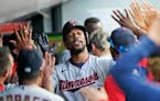Minnesota Twins' Byron Buxton celebrates with teammates after hitting a solo home run in the fifth inning of a baseball game against the Cleveland Ind