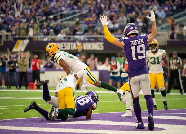 Minnesota Vikings wide receiver Adam Thielen (19) signaled the touchdown as Minnesota Vikings wide receiver Justin Jefferson (18) scored on a nine yar