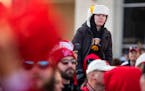 Iowa fan Jausten Baumgarn, 12, of Lake Park, Iowa, sits atop the shoulders of Sterling Haack, 17, of Maurice, Iowa, while waiting to watch the Nebrask