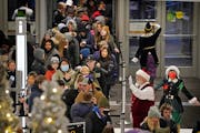 Santa and his elves greet Black Friday shoppers at the Mall of America’s North entrance Friday, Nov. 26, 2021 in Bloomington.