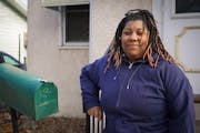 Latora Thompson, who previously rented from landlord Steven Meldahl, poses for a photo outside her new home in Minneapolis on Friday.