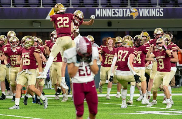 Lakeville South players celebrate after stopping Maple Grove on a final fourth down play to seal their 13-7 victory i