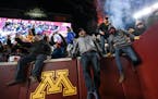 Minnesota fans storm the field after an NCAA football game between the Gophers and the Wisconsin Badgers.